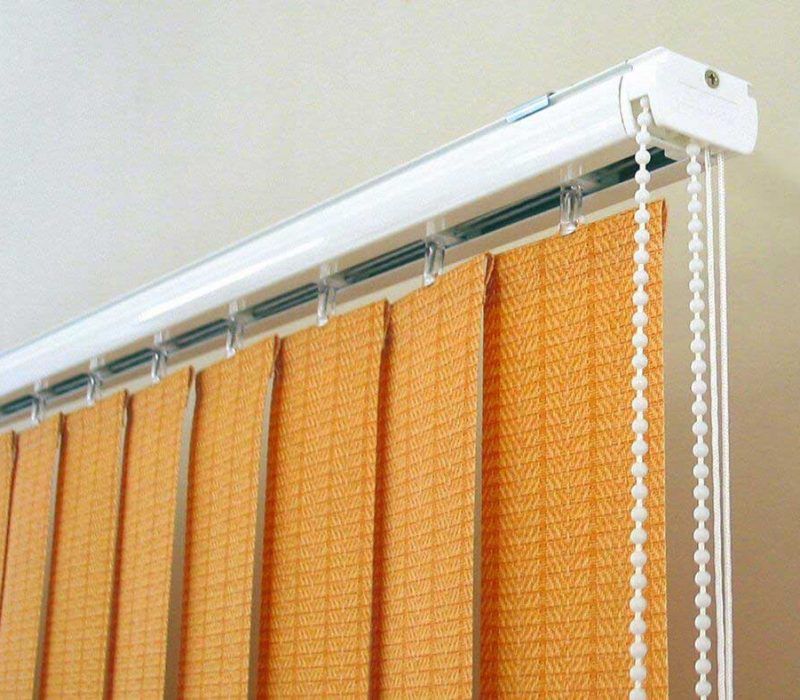 Close-up of the white headrail, carriers and bead chain of orange vertical blinds