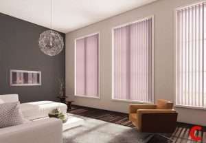 Pale pink vertical blinds on three narrow windows beside a charcoal feature wall and white sofa