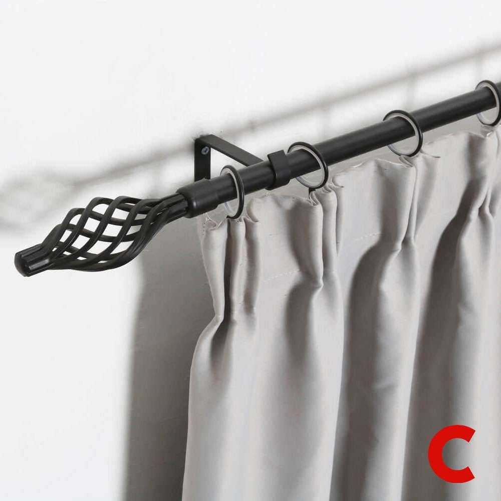Black metal curtain pole with a twisted birdcage finial, holding a plain grey pleated curtain on silver rings