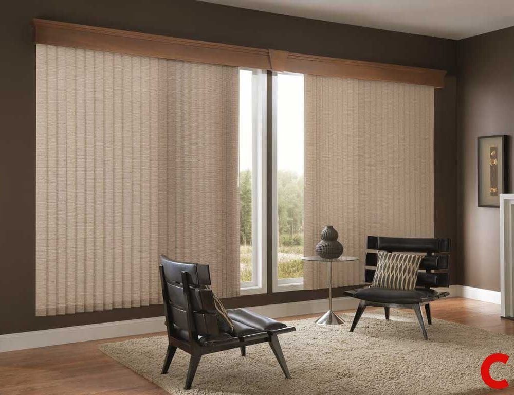 Oatmeal fabric vertical blinds under a wooden pelmet across a wide window in a dark brown-walled lounge