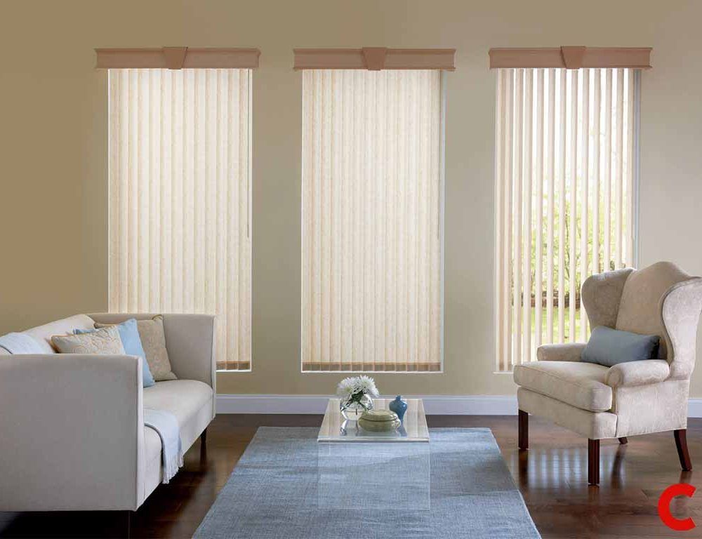 Cream vertical blinds under matching pelmets on three windows, the right one angled open onto a green garden