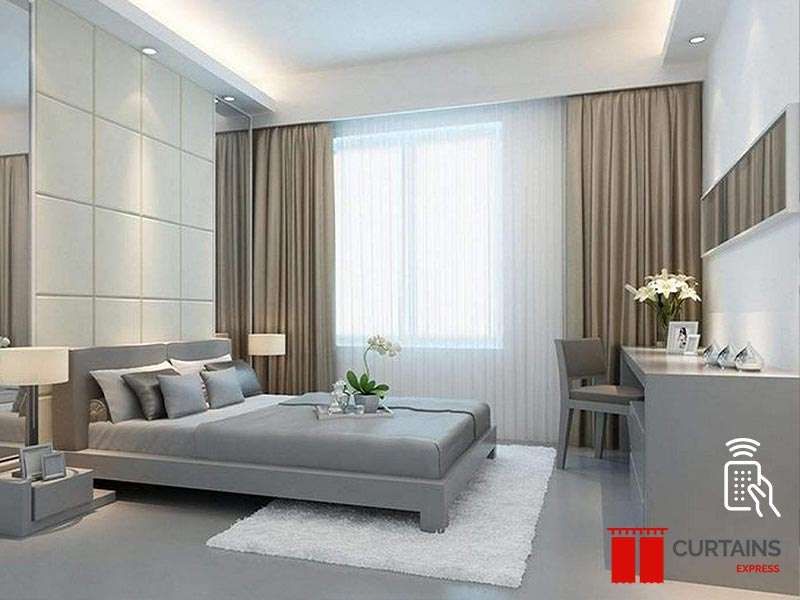 Computer-rendered bedroom with taupe curtains and a white sheer at the window, beside a grey bed and desk