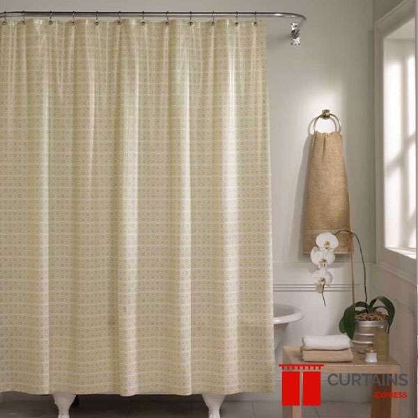 Cream textured shower curtain on a curved rail around a clawfoot bath, hessian towel hanging on a ring