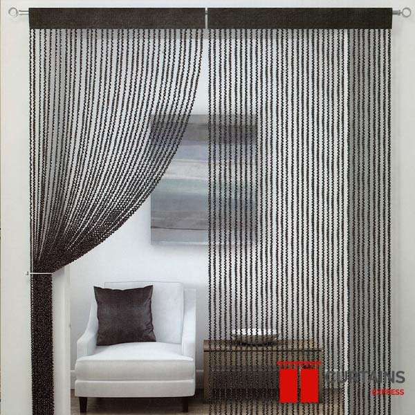 Black string curtain with a solid heading band across a doorway, one half swept back over a white armchair