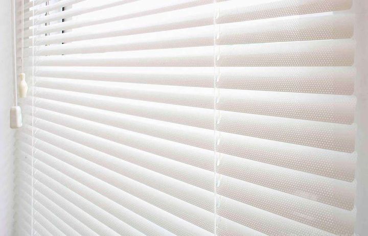 Detail of perforated aluminium venetian blind slats