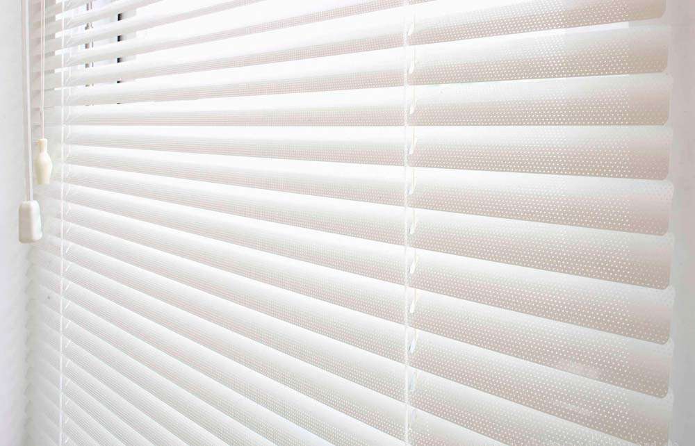 Detail of perforated aluminium venetian blind slats