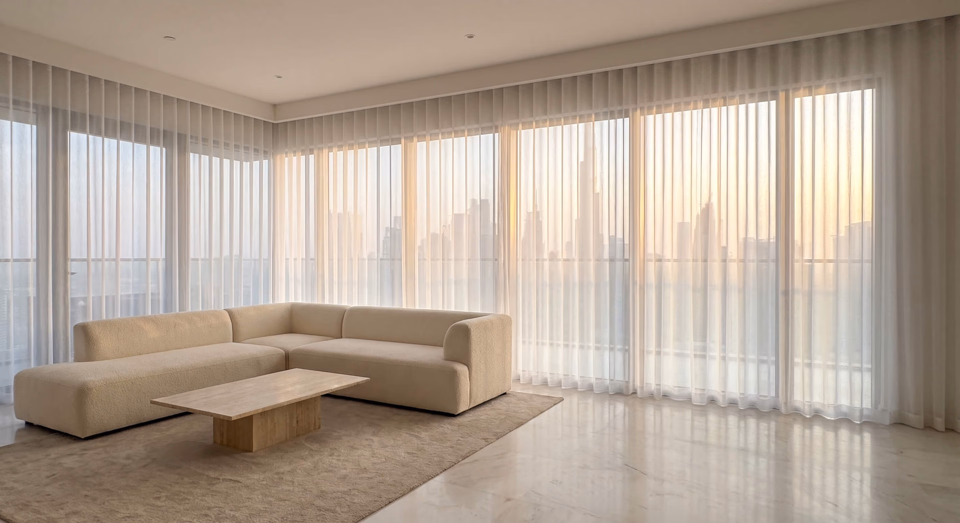 Tower living room at sunset, white sheer wave curtains closed along two walls of glass, the Burj Khalifa and skyline showing through